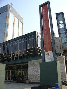 The Francis Winspear Centre for Music with a banner in front for the Edmonton Symphony Orchestra and Century Place tower behind it.